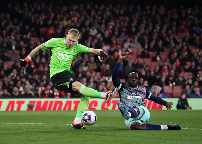 Yoane Wissa pictured (right) scoring for Brentford by tackling Arsenal goalkeeper Aaron Ramsdale during a Premier League game in March 2024